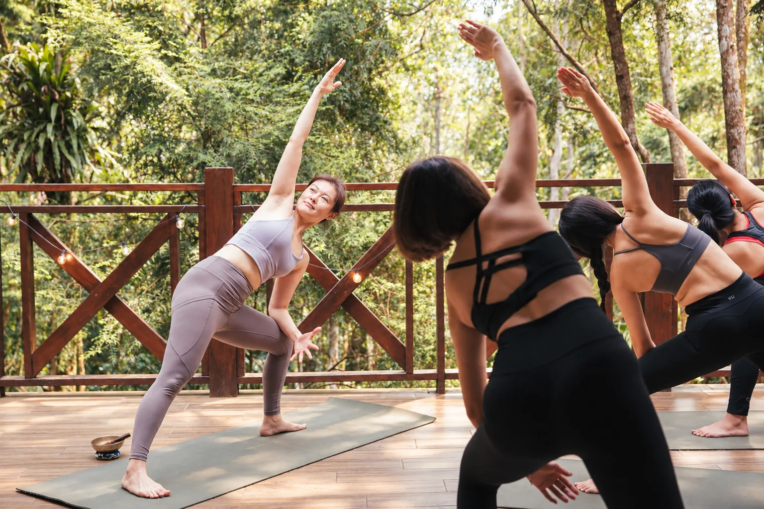 A teacher leading a side stretch on the terrace